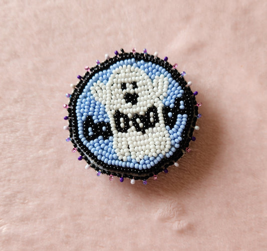 Fully beaded phone grip, featuring a ghost and the letters "ooooooo" across their chest. Outlined in black and on a furry, pink background.